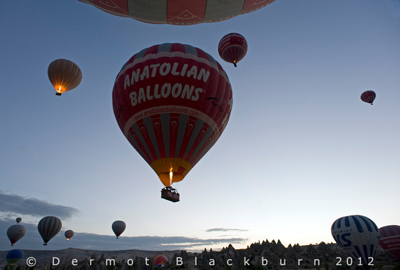Hot air balloons lifting off, Göreme, Cappadocia, Turkey.